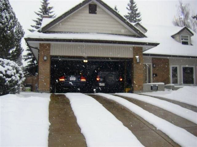 Radiant heated driveway with visible heated tire tracks